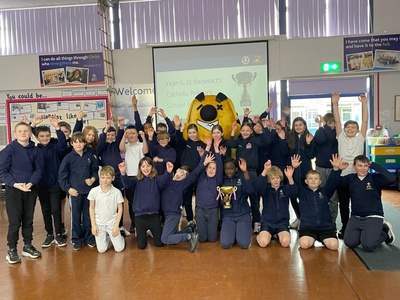A group photo of a school class with a giant Sumdog mascot.